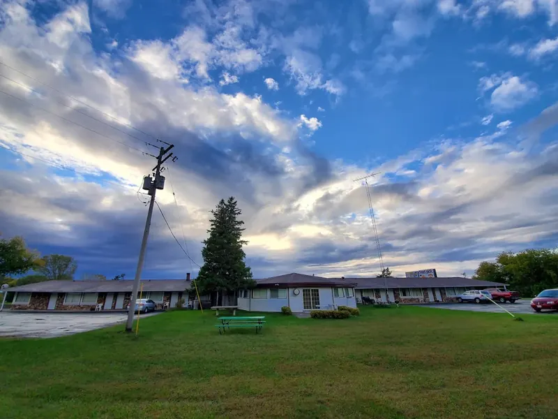 Evening sky over the lawn and the long, low motel building