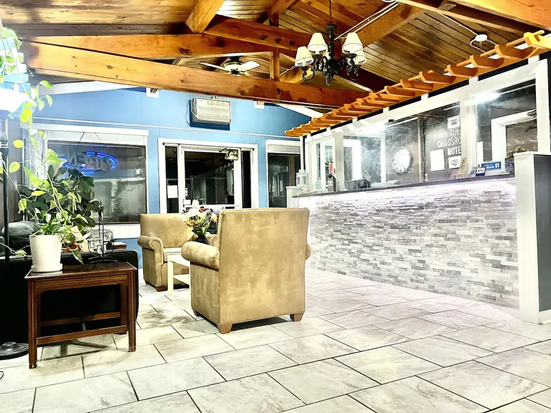Lobby with chandelier, front desk and armchairs