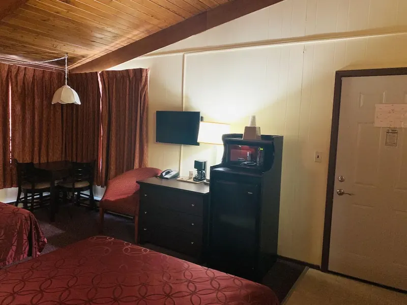 Dresser, microwave and dining table in the room