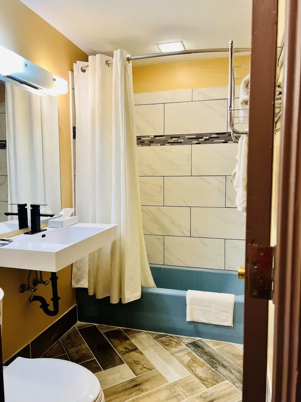Bathroom with tiled tub and shower